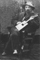 Man In A Chair With Cigar Box Mandolin
